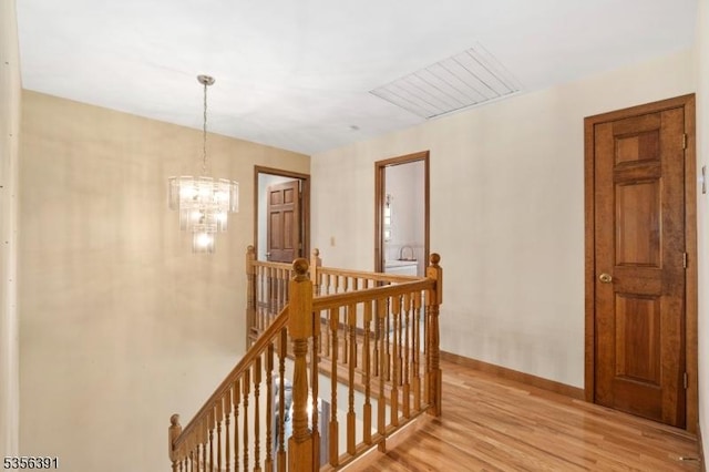 75 Wolfs Corner Rd, Green Twp, NJ 07860 - corridor with an upstairs landing, light wood-style floors, a chandelier, and baseboards