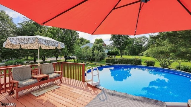 12 Fox Chase Run, Hillsborough Twp, NJ 08844 - swimming pool featuring a wooden deck, view of wooded area, and a yard