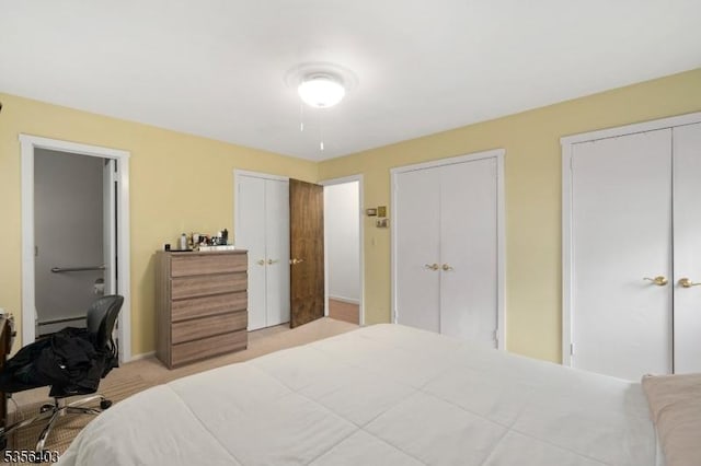 87 Ivy Ln, Bridgewater Twp, NJ 08807 - bedroom with a baseboard heating unit, multiple closets, light carpet, and baseboards