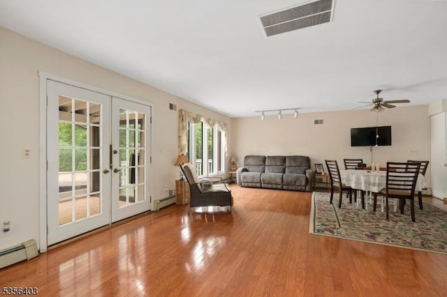 87 Ivy Ln, Bridgewater Twp, NJ 08807 - living area featuring french doors, baseboard heating, wood finished floors, and track lighting