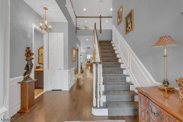 16 Gordon Way, Mount Olive Twp, NJ 07836 - stairs featuring a decorative wall, wood finished floors, a chandelier, and wainscoting