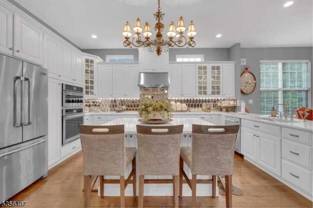 16 Gordon Way, Mount Olive Twp, NJ 07836 - kitchen with appliances with stainless steel finishes, under cabinet range hood, a chandelier, tasteful backsplash, and light countertops