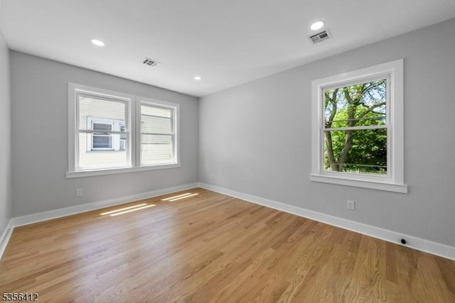 unfurnished room featuring baseboards, light wood-style flooring, and recessed lighting