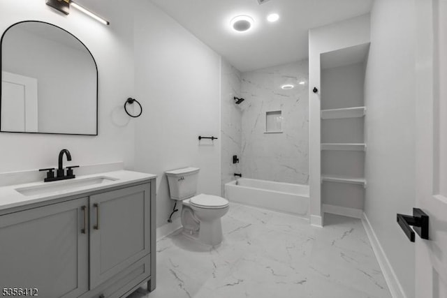 bathroom featuring marble look tile flooring, baseboards, vanity, and toilet