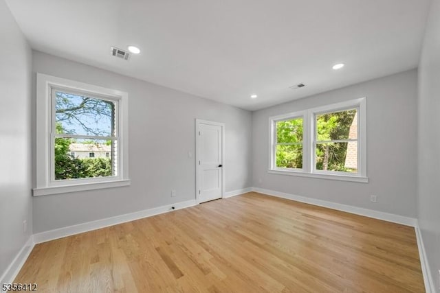 spare room with healthy amount of natural light, baseboards, and recessed lighting