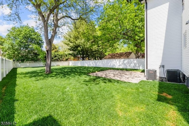 view of yard with central AC and a patio area