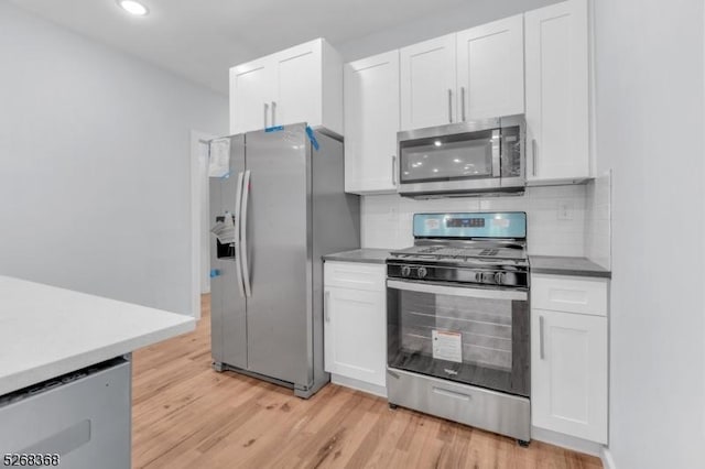 kitchen with appliances with stainless steel finishes, white cabinetry, and recessed lighting