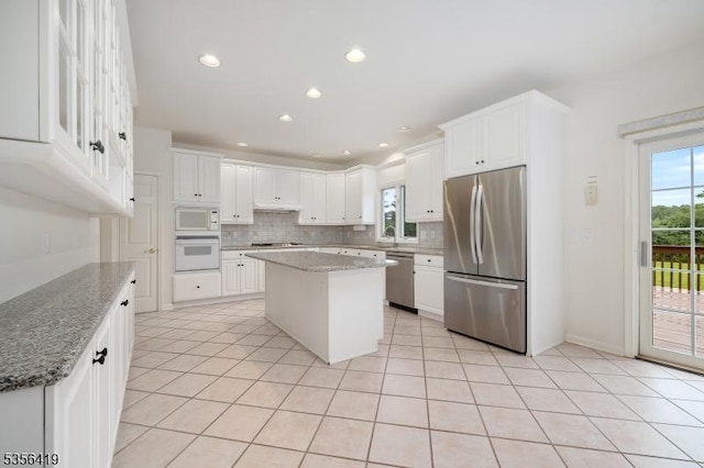 1 Joss Way, Long Hill Twp, NJ 07946 - kitchen with stainless steel appliances, tasteful backsplash, white cabinetry, light tile patterned flooring, and light stone countertops
