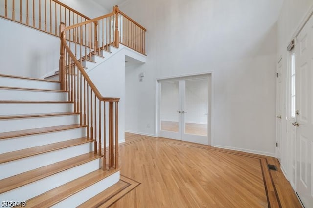 1 Joss Way, Long Hill Twp, NJ 07946 - entrance foyer with stairway, french doors, light wood-style floors, and a towering ceiling