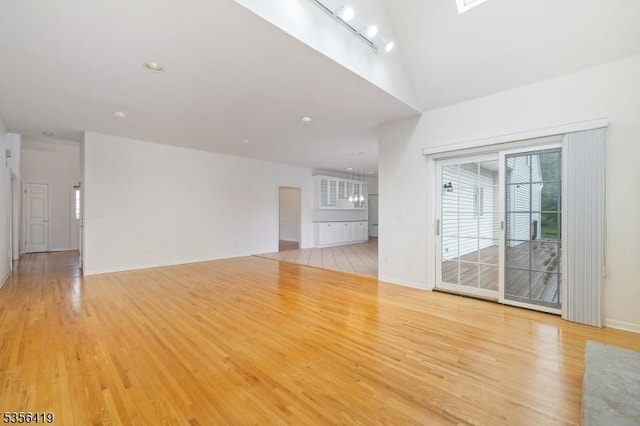 1 Joss Way, Long Hill Twp, NJ 07946 - unfurnished living room featuring light wood-type flooring and a towering ceiling