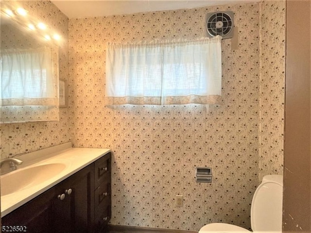 bathroom featuring toilet and vanity