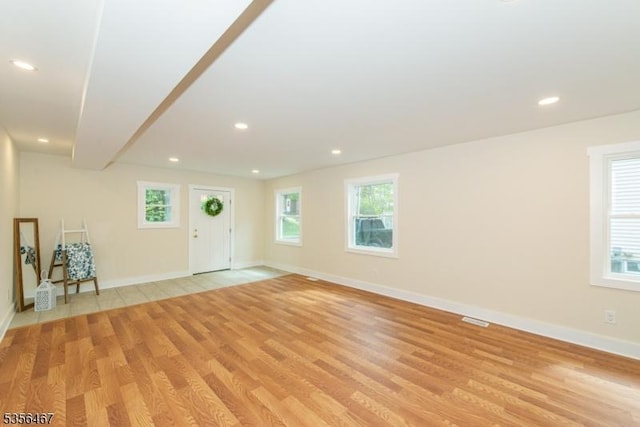unfurnished living room featuring light wood-style floors, recessed lighting, and baseboards