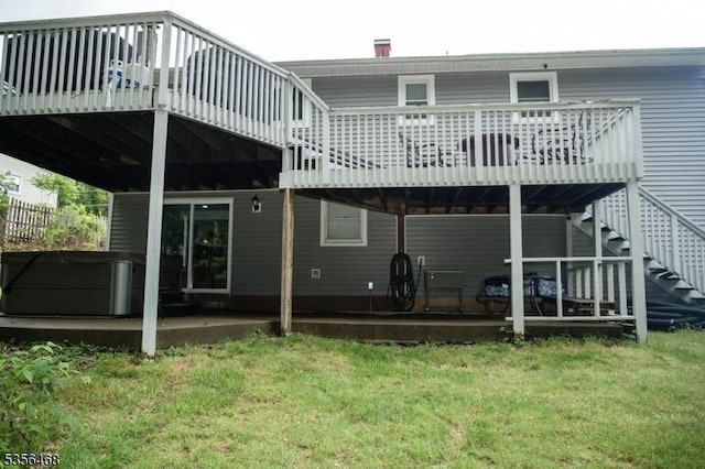 10 Lincoln Ave, Vernon Twp, NJ 07462 - back of property with a wooden deck, a patio area, a hot tub, and a yard