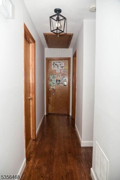 10 Lincoln Ave, Vernon Twp, NJ 07462 - hallway with dark wood-type flooring, baseboards, and attic access