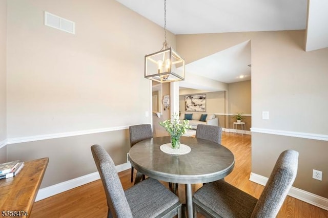 3522 Richmond Ct, Hillsborough Twp, NJ 08844 - dining room with wood finished floors, lofted ceiling, a chandelier, and baseboards