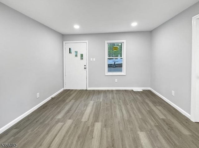 entrance foyer featuring wood finished floors, baseboards, and recessed lighting