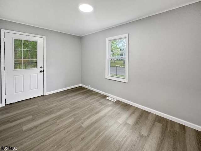 empty room with wood finished floors and baseboards