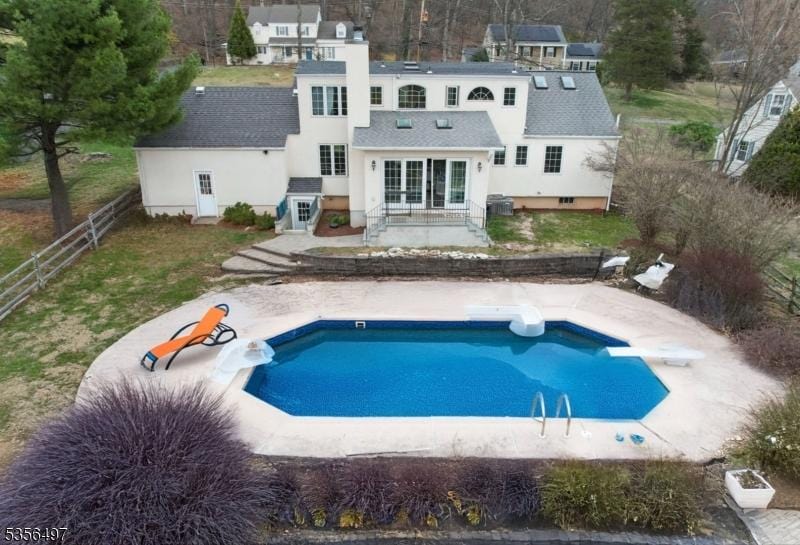 1111 Sky Hill Rd, Bridgewater Twp, NJ 08807 - back of property featuring stucco siding, a patio, fence, and an outdoor pool