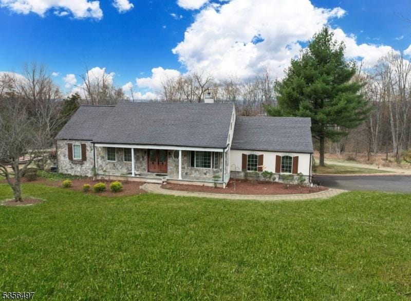 1111 Sky Hill Rd, Bridgewater Twp, NJ 08807 - ranch-style house featuring covered porch, a front lawn, a chimney, and stone siding