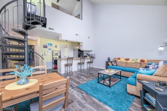 2 Davos Dr Unit 2, Vernon Twp, NJ 07462 - living room featuring stairs, a towering ceiling, wood finished floors, and baseboards