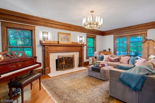 34 Crane Rd, Mountain Lakes Boro, NJ 07046 - living room featuring a chandelier, a fireplace, french doors, and wood finished floors