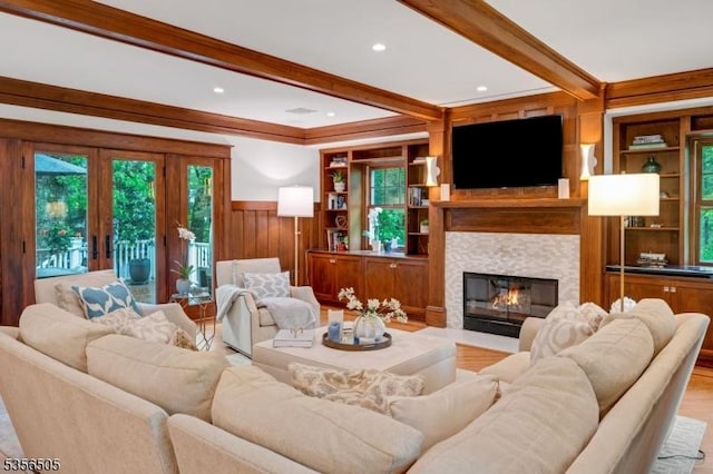 34 Crane Rd, Mountain Lakes Boro, NJ 07046 - living area with beamed ceiling, ornamental molding, a wainscoted wall, a fireplace with flush hearth, and wood finished floors