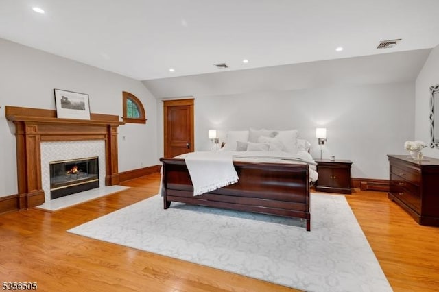 34 Crane Rd, Mountain Lakes Boro, NJ 07046 - bedroom featuring lofted ceiling, baseboards, light wood-style flooring, recessed lighting, and a tiled fireplace