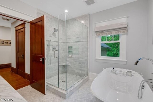 34 Crane Rd, Mountain Lakes Boro, NJ 07046 - bathroom with a shower stall, a freestanding bath, baseboards, a sink, and wood finished floors