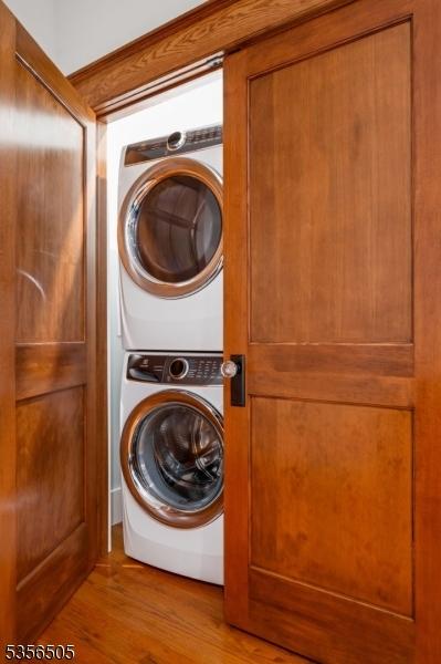 34 Crane Rd, Mountain Lakes Boro, NJ 07046 - laundry area featuring stacked washer and clothes dryer and wood finished floors