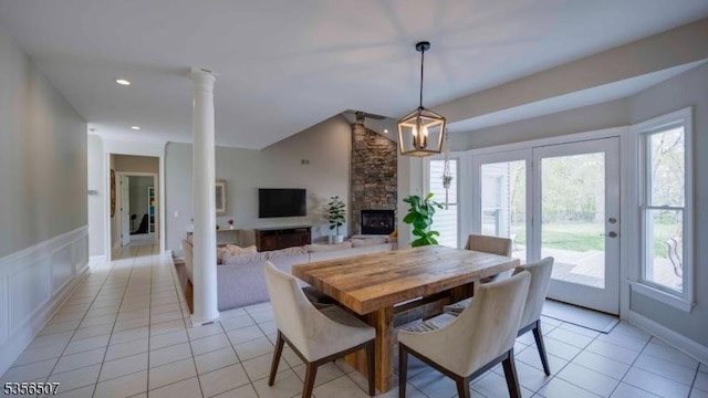 1 Dewing Ct, Raritan Twp, NJ 08551 - dining space with vaulted ceiling, a stone fireplace, light tile patterned floors, and ornate columns