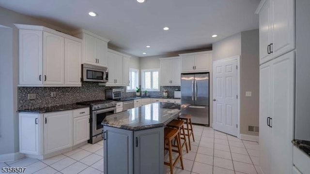 1 Dewing Ct, Raritan Twp, NJ 08551 - kitchen featuring appliances with stainless steel finishes, a kitchen breakfast bar, backsplash, white cabinets, and recessed lighting
