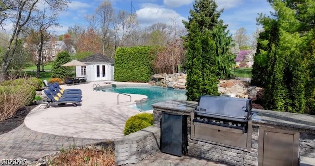1 Dewing Ct, Raritan Twp, NJ 08551 - view of swimming pool with exterior kitchen, fence, an exterior structure, a patio, and an outdoor structure