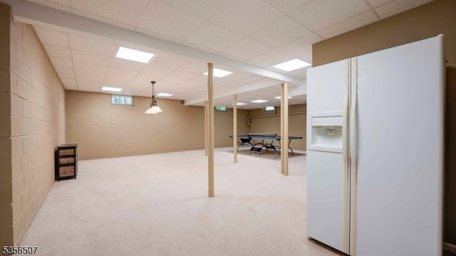 1 Dewing Ct, Raritan Twp, NJ 08551 - below grade area with white fridge with ice dispenser, a drop ceiling, carpet floors, and concrete block wall
