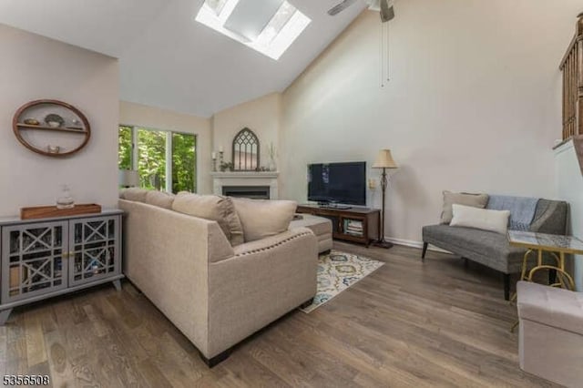 3 Saint Andrews Ln, Clinton Twp, NJ 08801 - living area with a fireplace, wood finished floors, high vaulted ceiling, a skylight, and ceiling fan