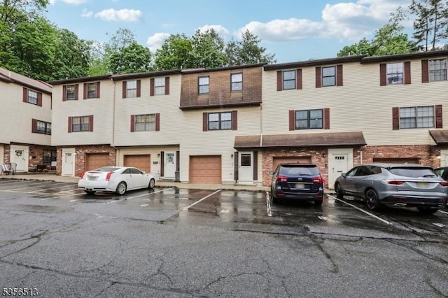 townhome / multi-family property featuring brick siding
