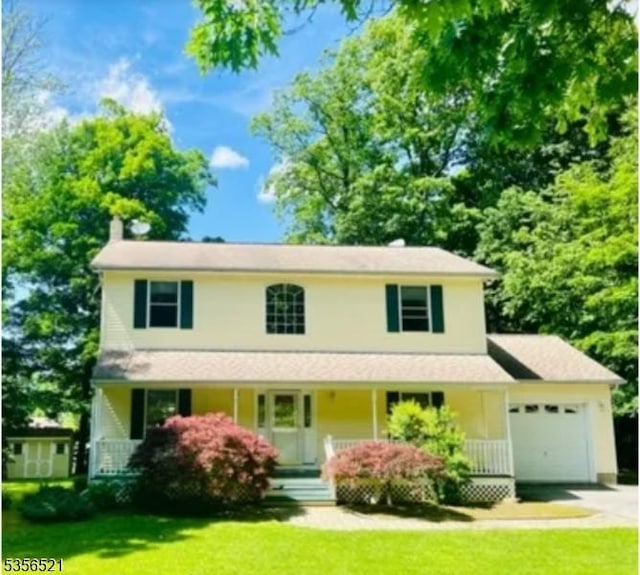 19 Esther Dr, Vernon Twp, NJ 07422 - view of front facade featuring an attached garage, a porch, driveway, and a front yard