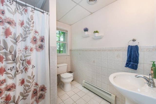 19 Esther Dr, Vernon Twp, NJ 07422 - bathroom with a baseboard radiator, tile walls, tile patterned floors, toilet, and a sink