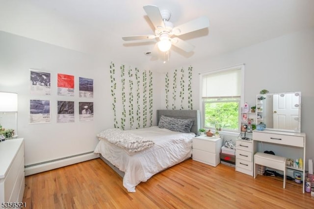 19 Esther Dr, Vernon Twp, NJ 07422 - bedroom featuring a baseboard heating unit, light wood-type flooring, and a ceiling fan
