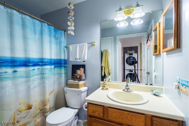 bathroom with stacked washer / dryer, toilet, and vanity