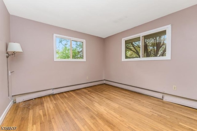 empty room featuring light wood finished floors and baseboards