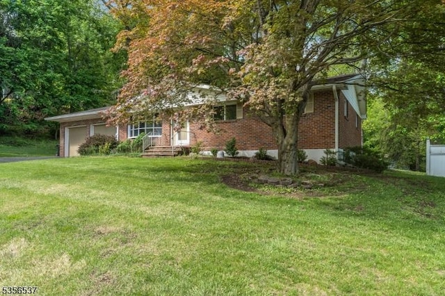 obstructed view of property with brick siding, a garage, a front lawn, and driveway