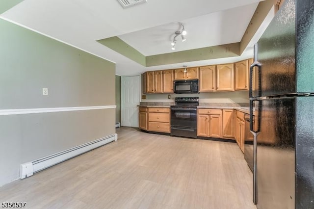 kitchen featuring black appliances, a baseboard heating unit, a tray ceiling, and light wood-style floors