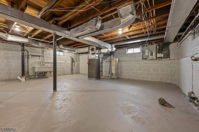 basement with water heater, a sink, heating unit, and electric panel