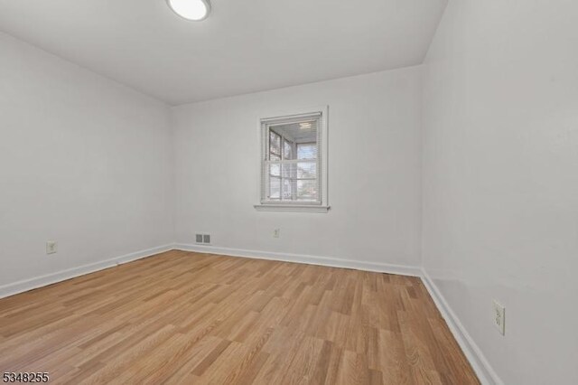 unfurnished room featuring light wood-type flooring and baseboards