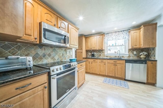 129 River Dr, Parsippany-Troy Hills Twp, NJ 07034 - kitchen featuring appliances with stainless steel finishes, a sink, light wood-type flooring, decorative backsplash, and recessed lighting