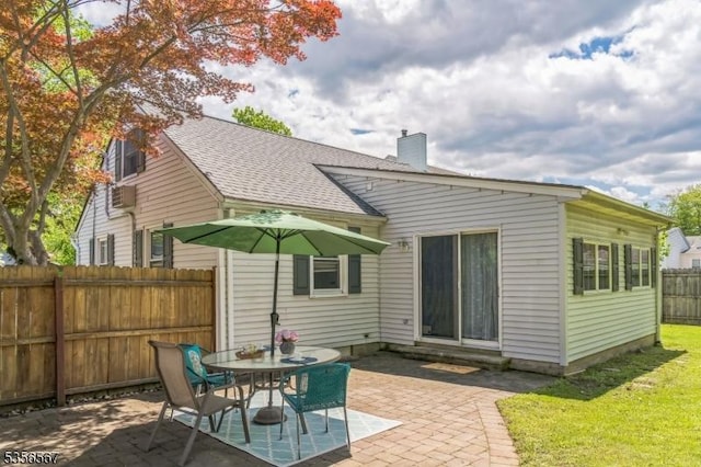 129 River Dr, Parsippany-Troy Hills Twp, NJ 07034 - back of property with a patio, a chimney, and a shingled roof