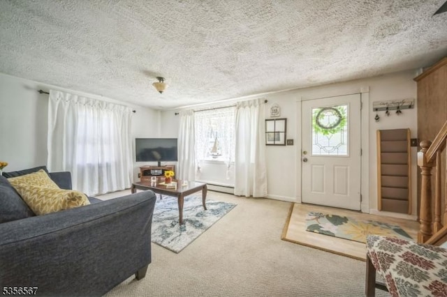 129 River Dr, Parsippany-Troy Hills Twp, NJ 07034 - carpeted living area with a textured ceiling, stairs, and a baseboard heating unit
