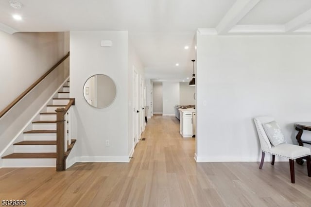 hall featuring light wood finished floors, stairway, baseboards, and recessed lighting