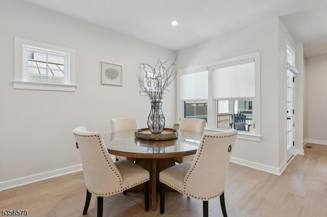 dining area with baseboards, light wood-style floors, and recessed lighting