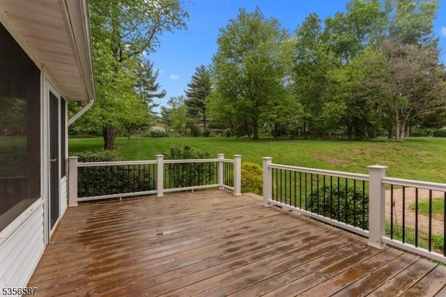 wooden terrace featuring a yard and view of scattered trees